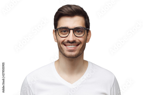 Close-up shot of smiling attractive man in casual t-shirt and trendy eyeglasses isolated on white background