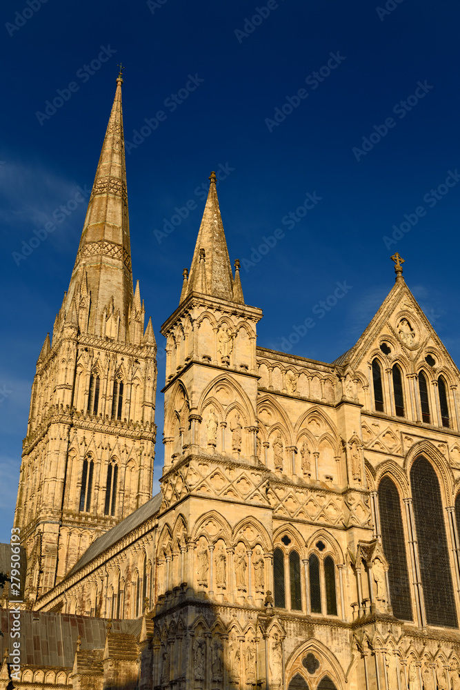 Great West Front facade of Salisbury Cathedral with Spire in late evening light in Salisbury England