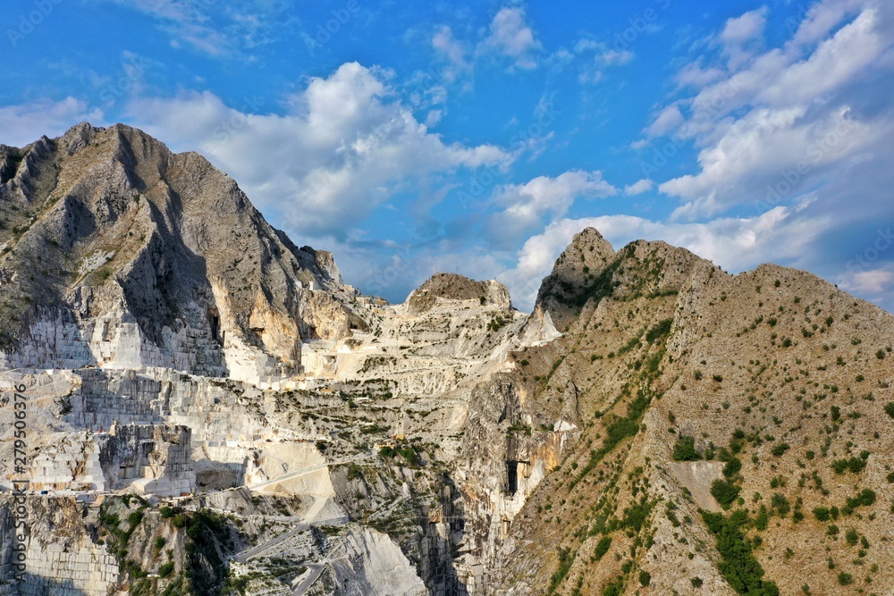 Aerial view of mountain of stone and marble quarries in the regional natural park of the Apuan Alps located in the Apennines in Tuscany, Massa Carrara Italy. Open pit mine