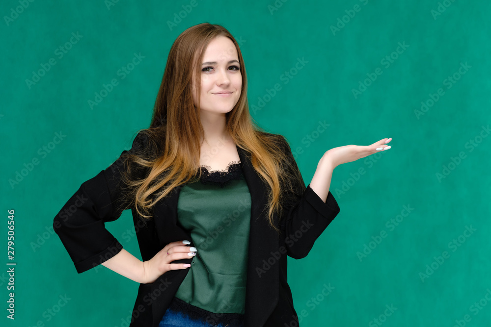 Concept portrait for a belt of a pretty girl, young woman with beautiful brown hair and in a black jacket and green T-shirt on a green background. In the studio in different poses showing emotions. Concept portrait for a belt of a pretty girl, young woman with beautiful brown hair and in a black jacket and green T-shirt on a green background. In the studio in different poses showing emotions.