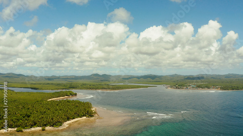 Village near mangroves in the bay of the ocean, top view. Siargao island, Philippines.