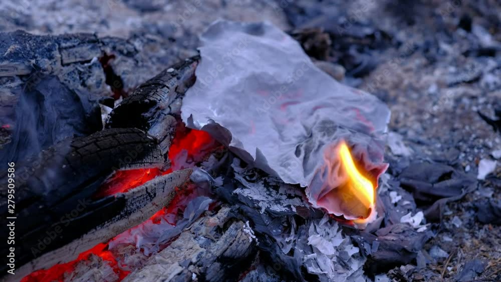 Close up, Letters, sheets of paper burning in the fire in the forest. The smoldering ash and scatters in the wind. 4k uhd Close up, Letters, sheets of paper burning in the fire in the forest. The smoldering ash and scatters in the wind. 4k uhd