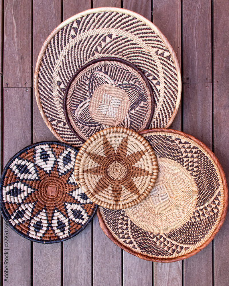 African grass baskets on a wooden background  - obrazy, fototapety, plakaty 