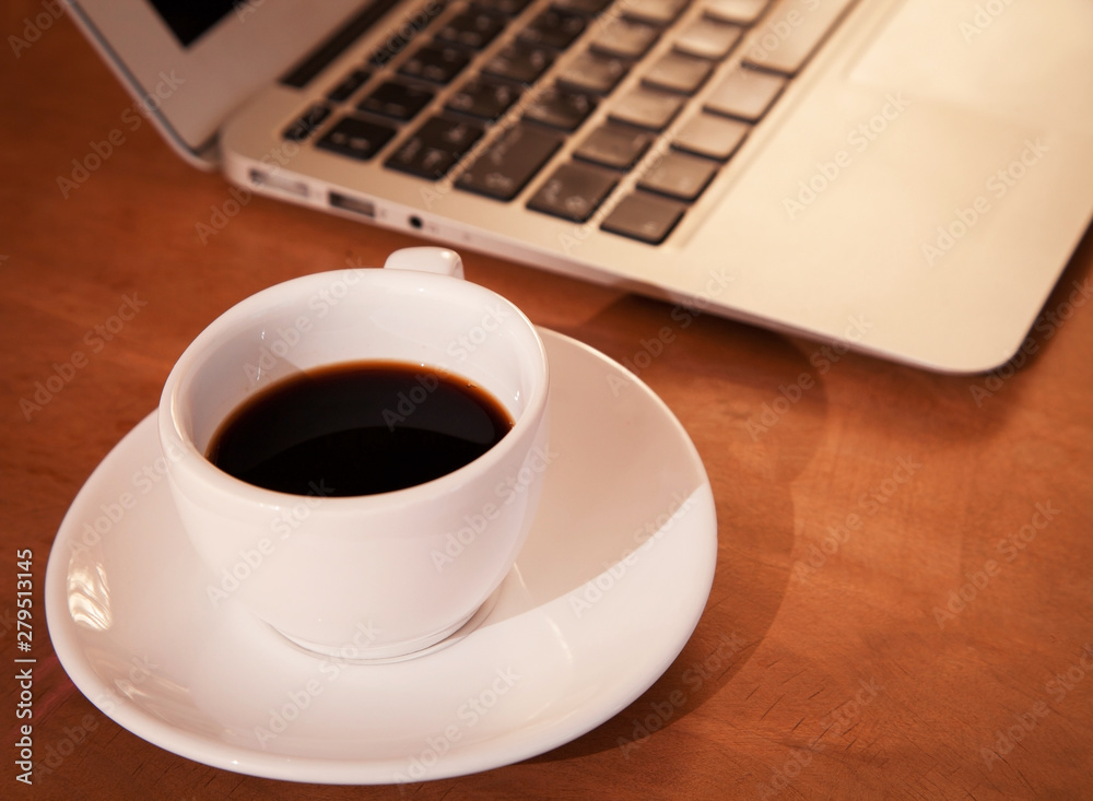 Laptop keyboard with coffee cup Laptop keyboard with coffee cup
