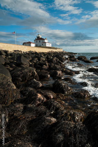 Coastal Seaweed Covers Rocks by Watch Hill Lighthouse in Rhode Island photo