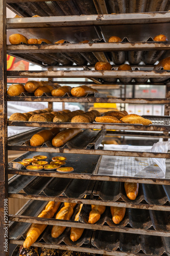 Freshly baked buns and pastry from oven at confectionery factory