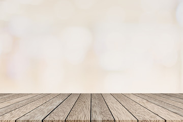abstract blurred cream color with bokeh light background with vintage wood table perspective for show,promote and advertisee product on display concept