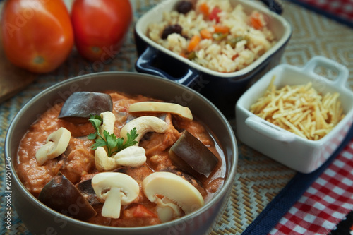 Vegan eggplant stroganoff with rice and potato sticks and salad