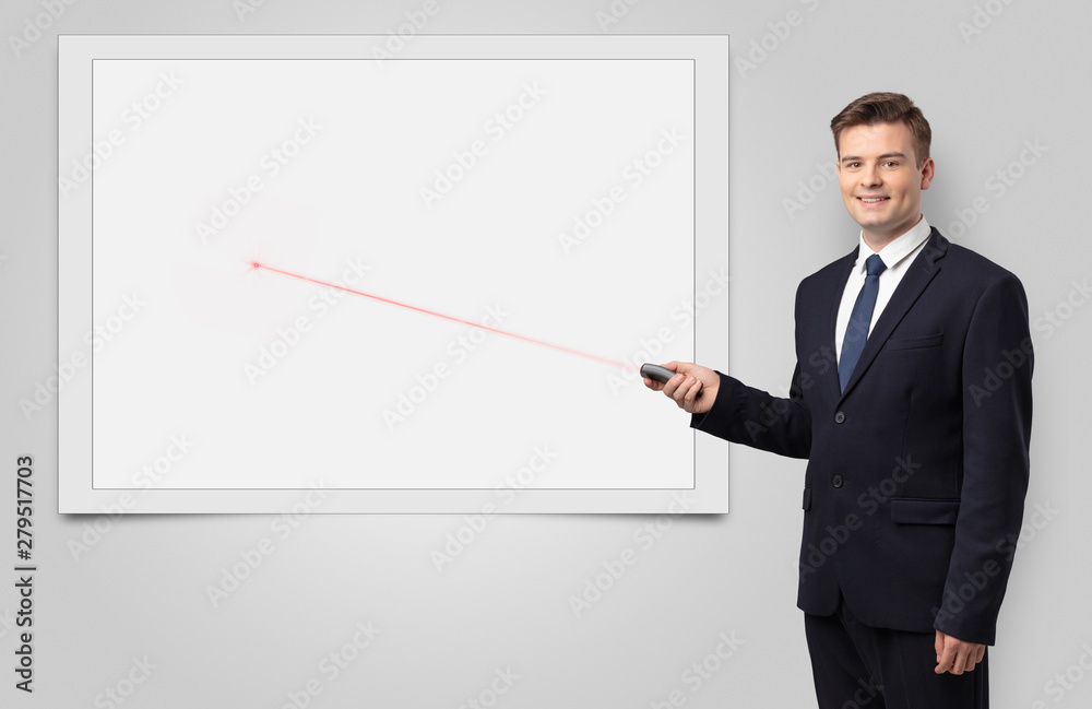 Young businessman with laser pointer and copyspace white blackboard Young businessman with laser pointer and copyspace white blackboard