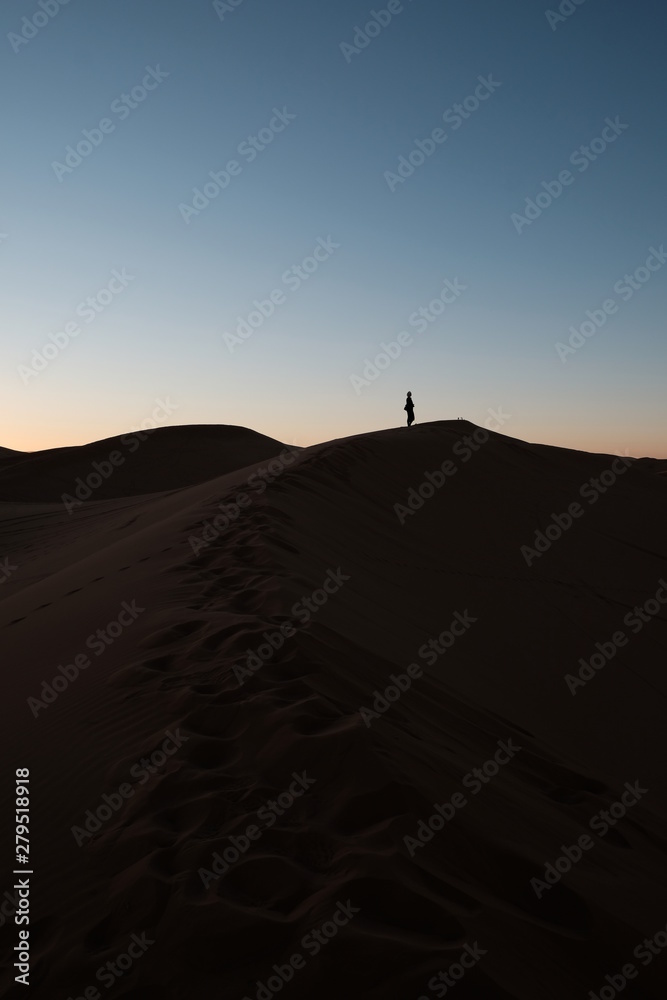 a person watching sunset in desert