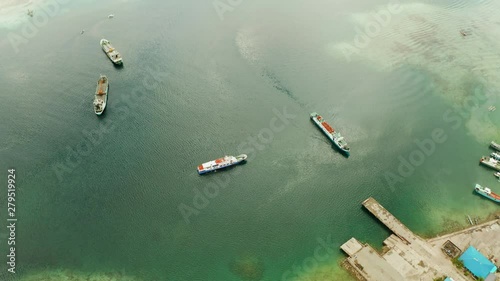 Freight ships and ferries in the bay, top view. Dapa Ferry Terminal. Siargao, Philippines. photo