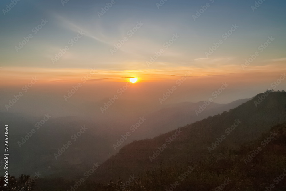 Mountain view morning of top hill around with soft fog and yellow sun light in the sky background, sunrise at top of Phu Ruea National Park, Phu Ruea District, Loei Province, Thailand. Mountain view morning of top hill around with soft fog and yellow sun light in the sky background, sunrise at top of Phu Ruea National Park, Phu Ruea District, Loei Province, Thailand.