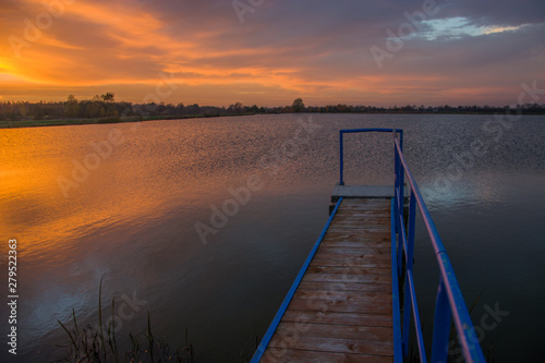 A bridge over the water and evening clouds after sunset