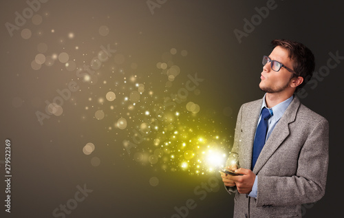 Person using phone with gold sparkling concept