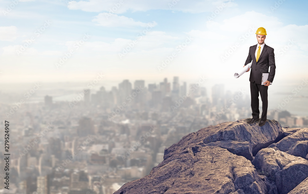 Young business person looking to the city from distance Young business person looking to the city from distance