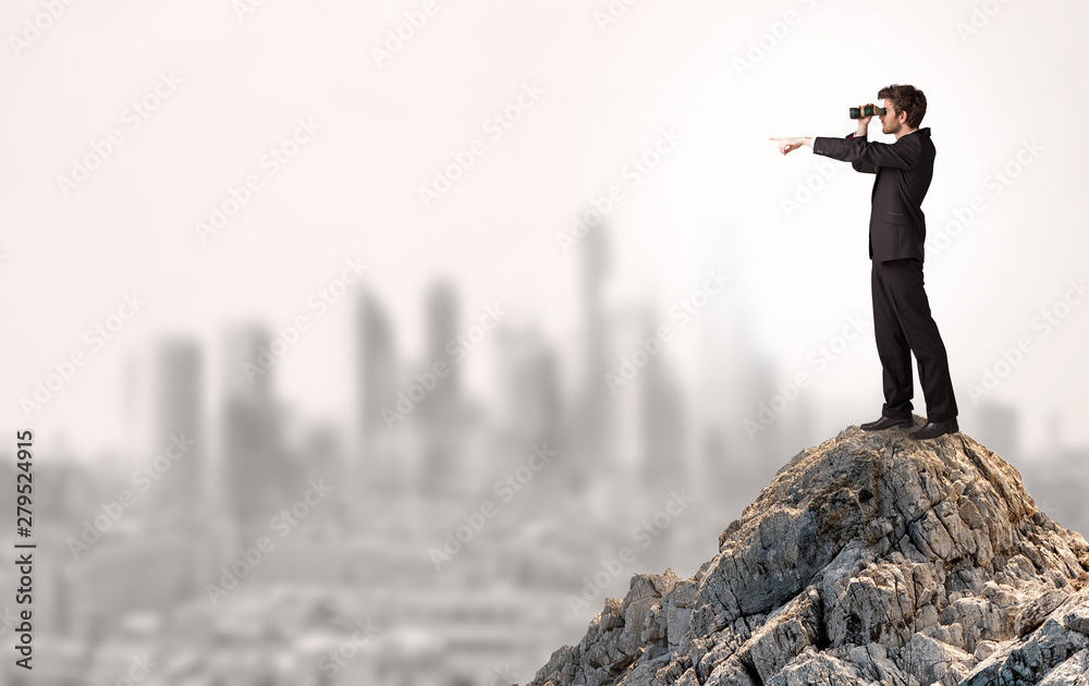 Young business person looking to the city from distance Young business person looking to the city from distance
