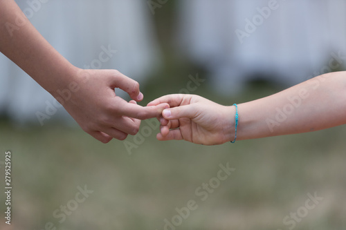 two hands touching, very young they touch their finger, love concept