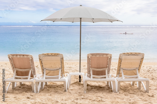 two chairs and umbrella on the beach