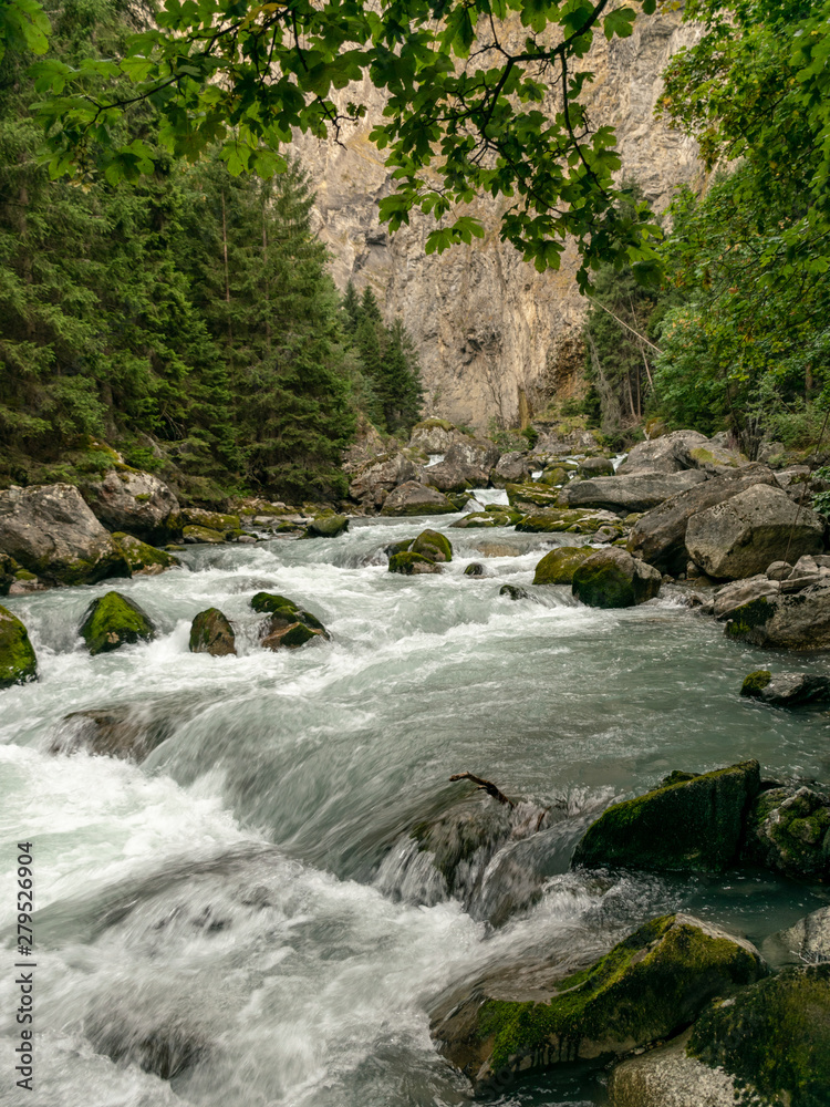 Fototapeta premium small river in the mountains, slow shutter speed for smooth water level and dreamy effect