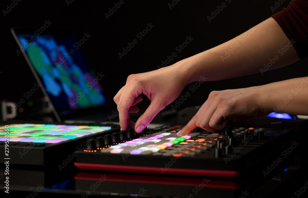 Dj hand remixing music on midi controller Dj hand remixing music on midi controller
