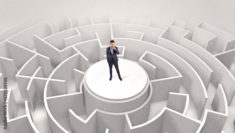 Businessman standing on the top a maze and looking through Businessman standing on the top a maze and looking through