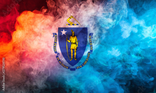 The national flag of the US state Massachusetts in against a gray smoke on the day of independence in different colors of blue red and yellow. Political and religious disputes, customs and delivery. photo