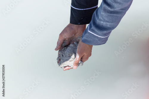 the woman hold Chyle or Argil or clay or sand in the hand at the Salda lake from Turkey. photo