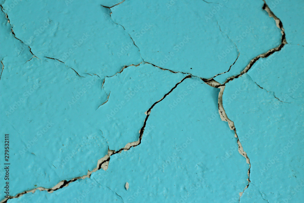 Obraz premium Wall with blue cracked paint close-up.