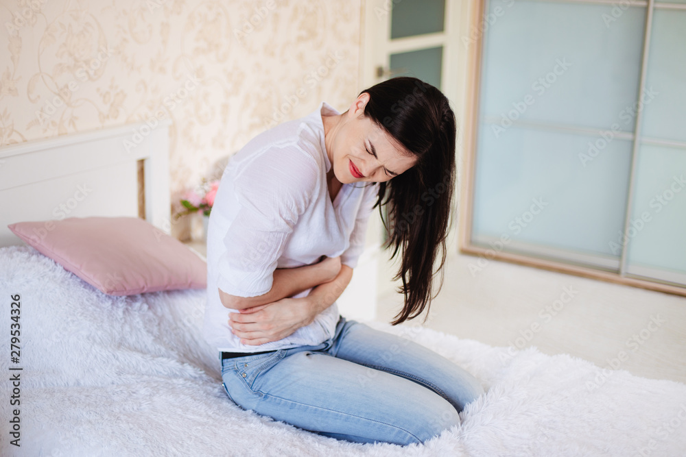 A young woman has a stomachache A young woman has a stomachache