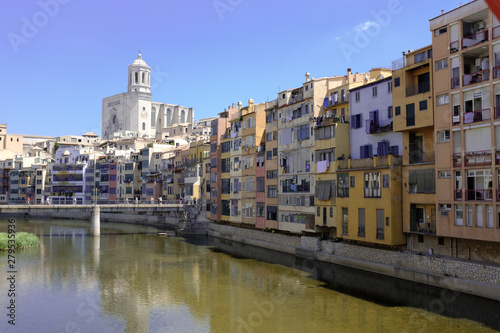 Girona's skyline with cathedral and bridge over the river landmarks on a blue Sunny day © jordieasy