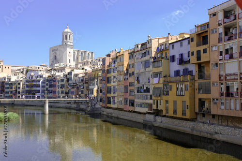 Girona's skyline with cathedral and bridge over the river landmarks on a blue Sunny day