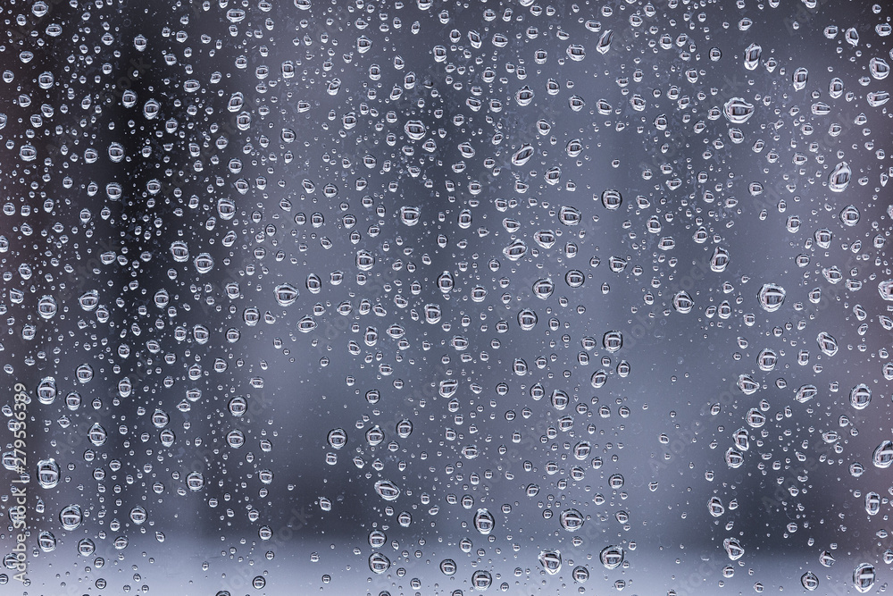 Water drops close up on a glass texture dark background Water drops close up on a glass texture dark background