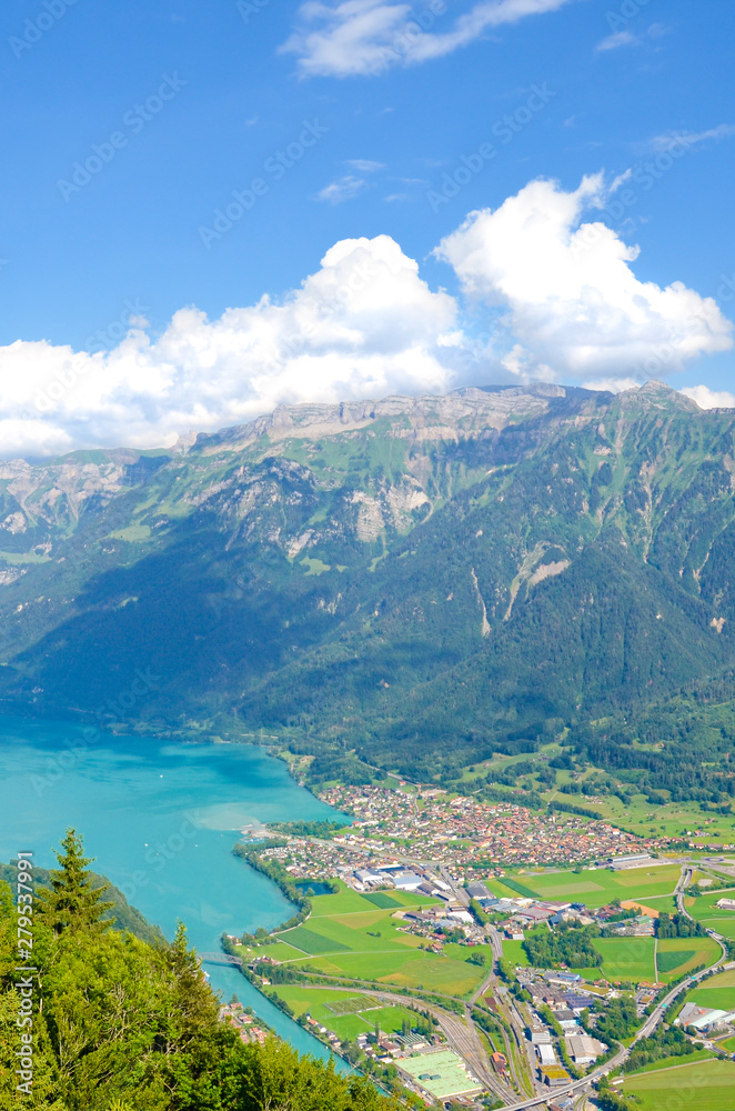 Turquoise Lake Brienz in Interlaken, Switzerland from above from Harder Kulm. Beautiful Swiss landscapes. Green hills, Swiss Alps. Summer Alpine landscapes. Amazing view