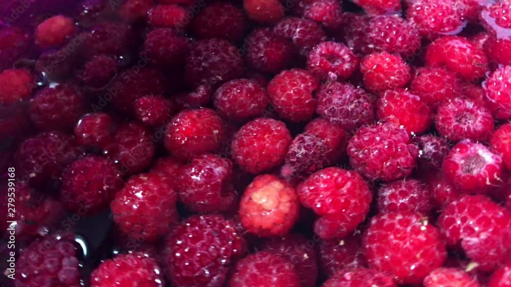 Red raspberries in a cup of water. Red raspberries in a cup of water.