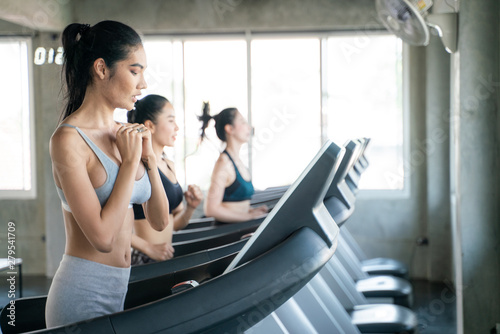 Group of sport asian women running on treadmill