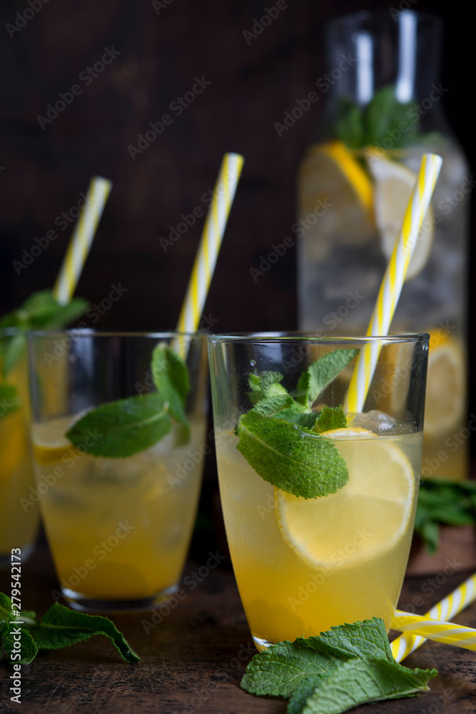 Fototapeta premium Homemade orange lemonade with citrus and mint on a dark wooden background