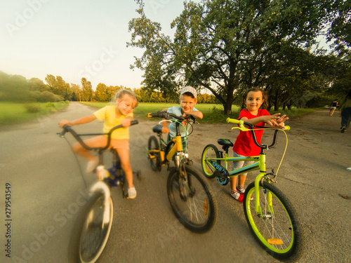 children on bicycles in the park near school.
