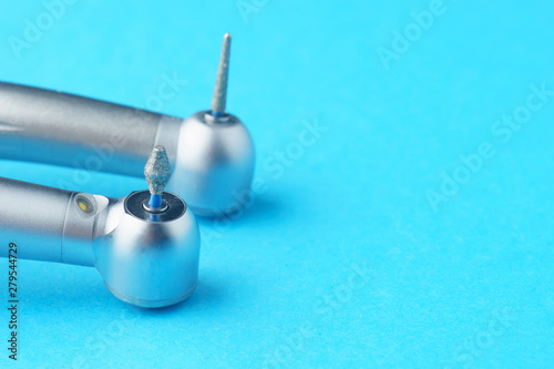 Dental metal bur on blue background, close-up, side view