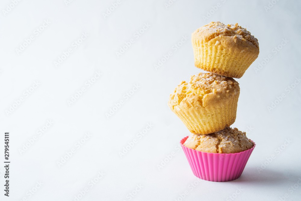 Tasty baked muffins on a light background, minimalism, a place for an inscription Tasty baked muffins on a light background, minimalism, a place for an inscription