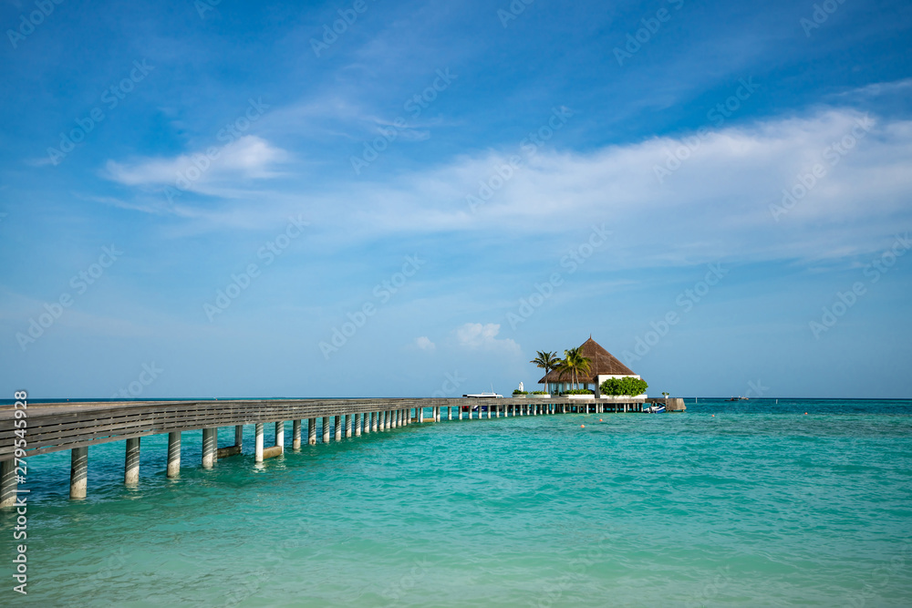 Wooden pier with blue sea and sky background