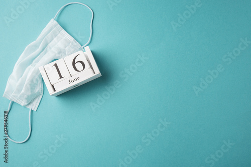 June 16, Day of the Medical Worker in Russia, wooden calendar on a blue background, a place for an inscription, top view
