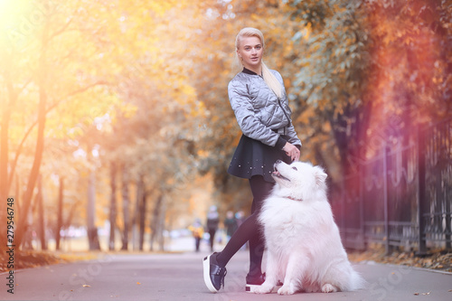 Lovely girl on a walk with a beautiful dog