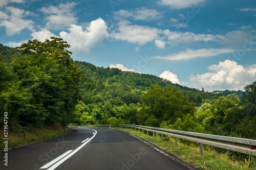 Road through mountain and forest, cloudy day. Road by the Ibar river in Serbia called Ibarska Magistrala