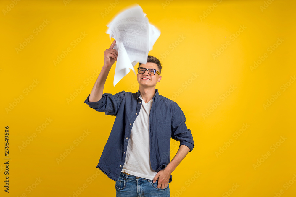 Image of man in glasses posing isolated over yellow wall background. People, business, job, profession and occupation. Ofice workerthrowing paper sheets up in the air after he failed project Image of man in glasses posing isolated over yellow wall background. People, business, job, profession and occupation. Ofice workerthrowing paper sheets up in the air after he failed project