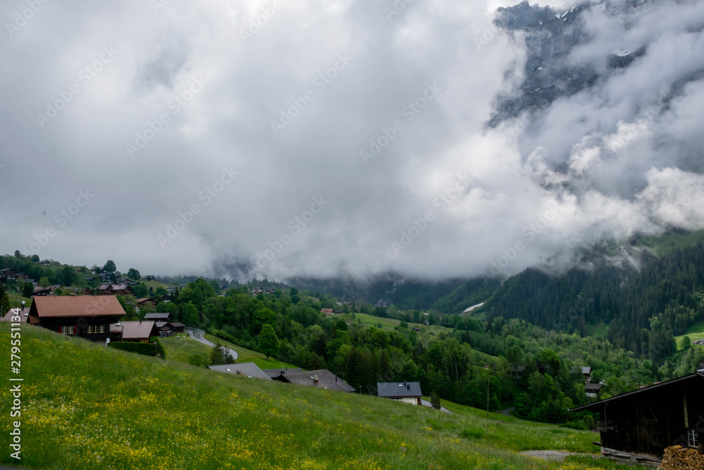 Beautiful scenic view on Grindelwald Village in Switzerland Alps mountains with low clouds, Grindelwald Switzerland