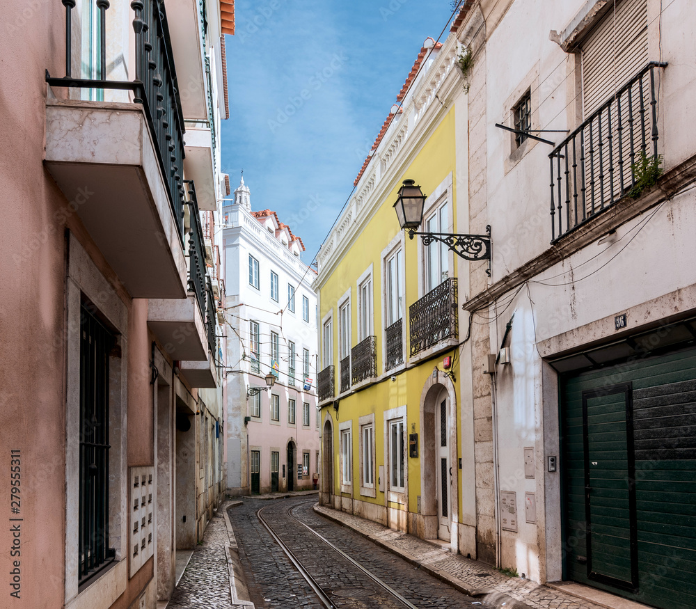 Quiet street with rails in the old city of Lisbon summer clear sunny day