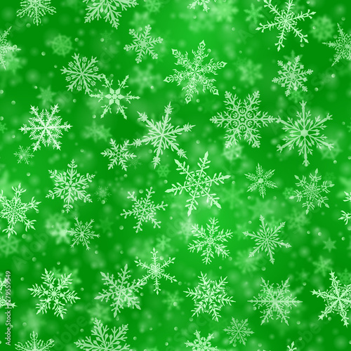 Christmas seamless pattern of complex blurred and clear falling snowflakes in green colors with bokeh effect