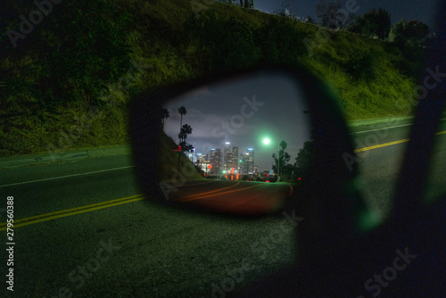Los Angeles downtown skyline at night reflected in side car mirror