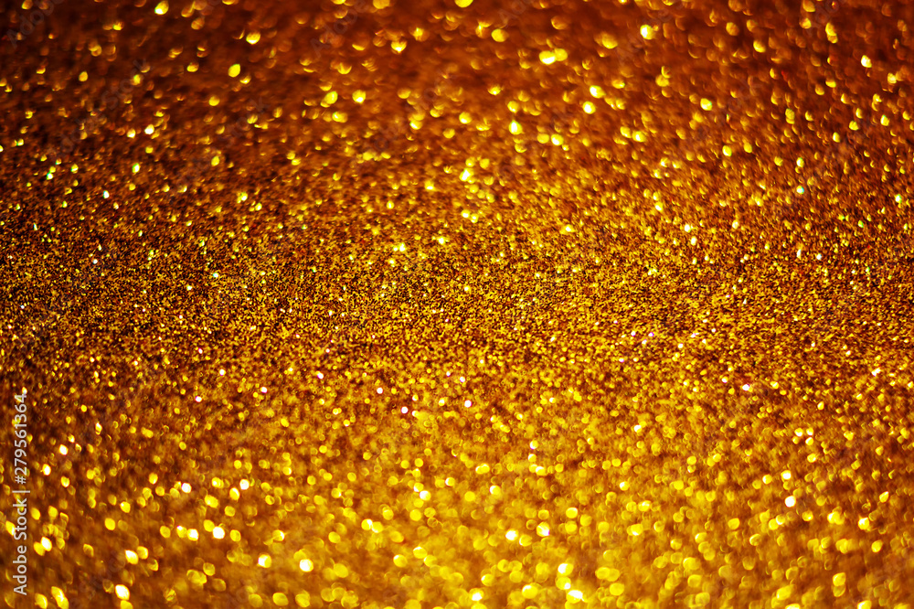 Festive abstract gold glitter texture background with shiny sparkle. Colorful defocused background with glittering and sparkling spots. Suitable for christmas,new year,chinese new year and designs