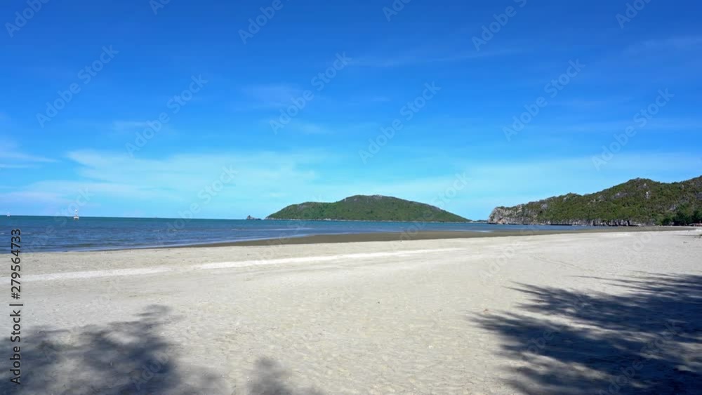 Slow pan across beautiful golden sands and blue seas in Thailands tropical coastline Slow pan across beautiful golden sands and blue seas in Thailands tropical coastline